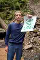 Free photo front view man holding banner