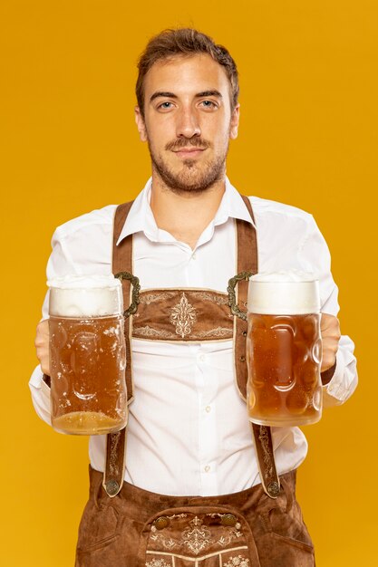 Front view of man holding beer pints