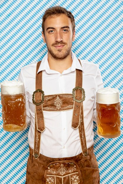 Front view of man holding beer pints