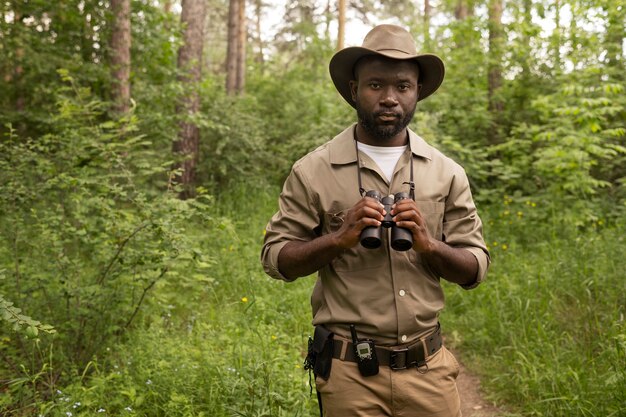 Front view man holding binoculars