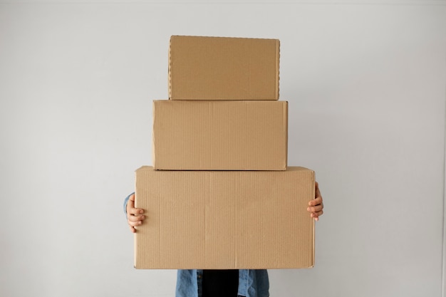 Free photo front view man holding boxes