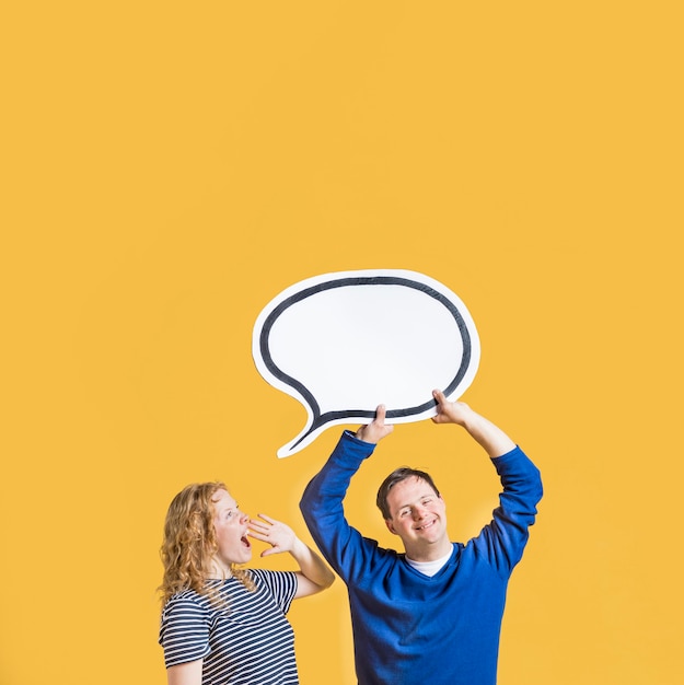 Free photo front view of man holding chat bubble with woman