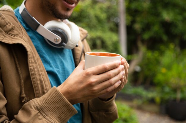 コーヒーマグを持って男の正面図