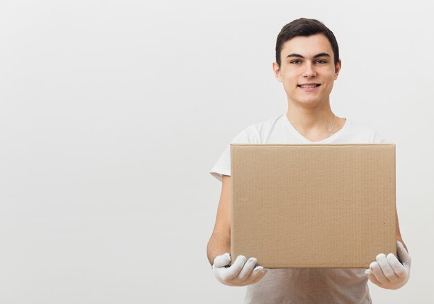 Front view man holding delivery box