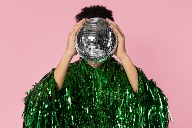 Front view man holding disco ball
