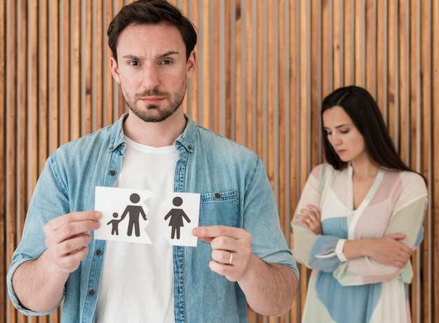 Free photo front view man holding family paper