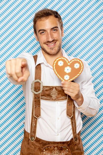 Front view of man holding gingerbread