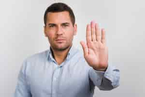 Free photo front view of man holding his palm up