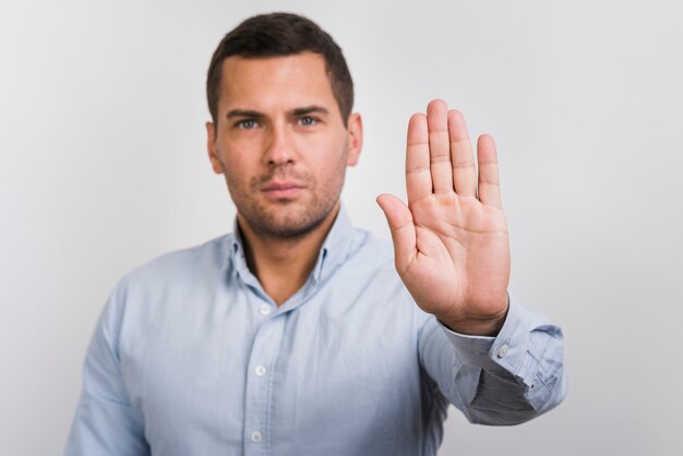 Front view of man holding his palm up