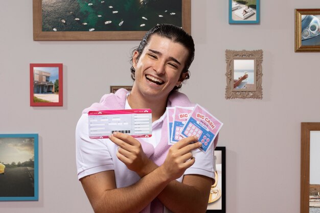 Front view man holding lottery tickets