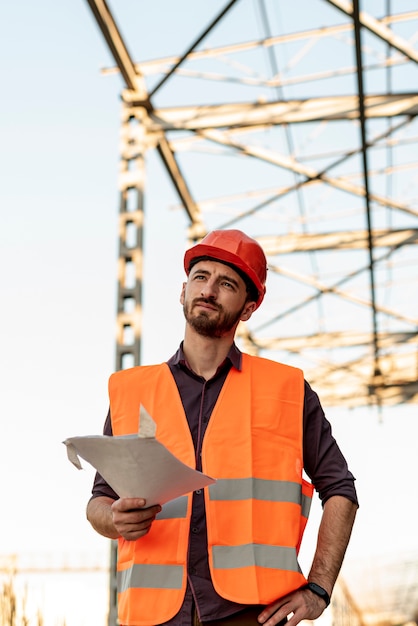 Free photo front view of man holding plan