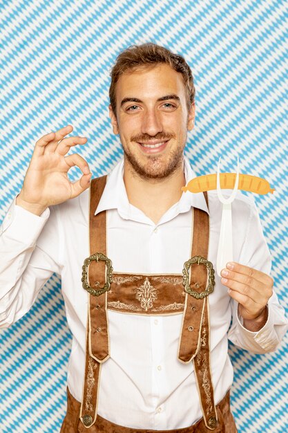 Front view of man holding sausage