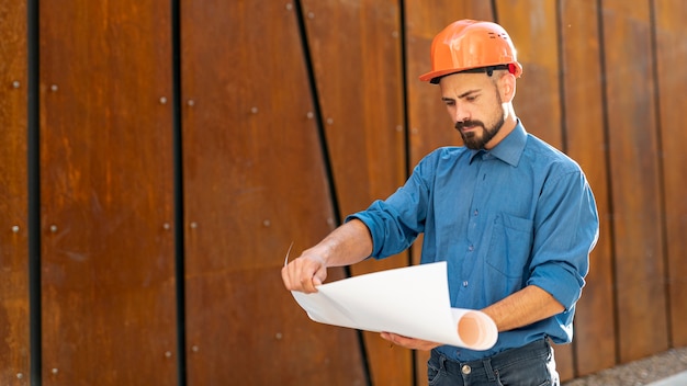 Front view of man holding schematics