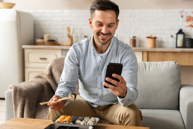 Front view man holding smartphone