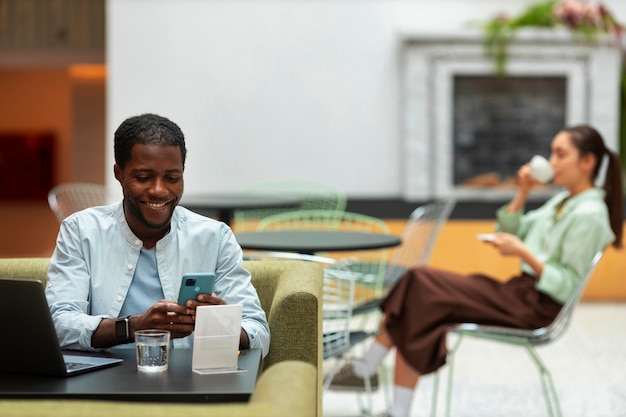 Free photo front view man holding smartphone