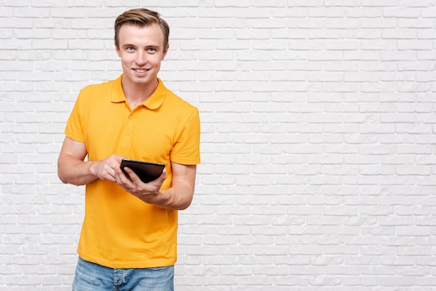 Front view man holding a tablet