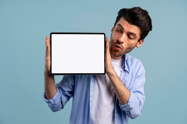 Free photo front view of man holding tablet