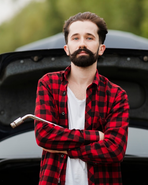 Free photo front view of man holding wrench