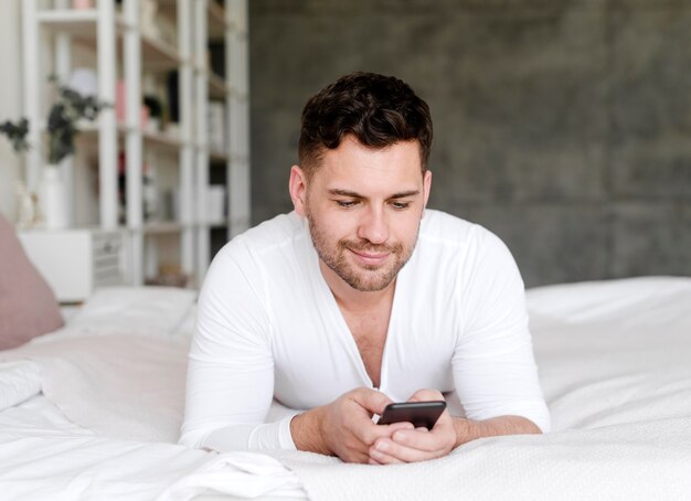 Front view man laying in bed