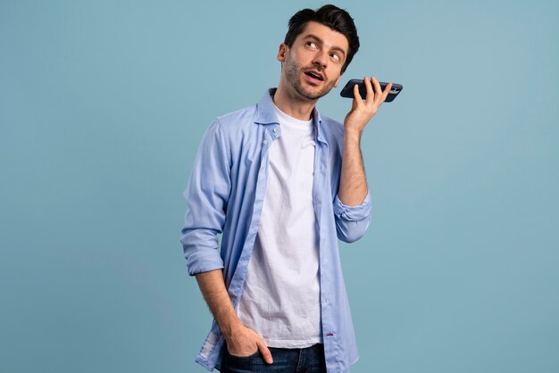 Front view of man listening to his smartphone