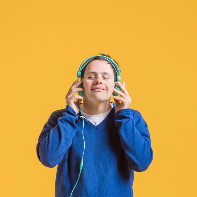 Front view of man listening to music on headphones