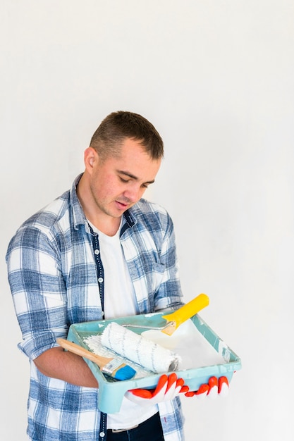 Front view of man looking at a box