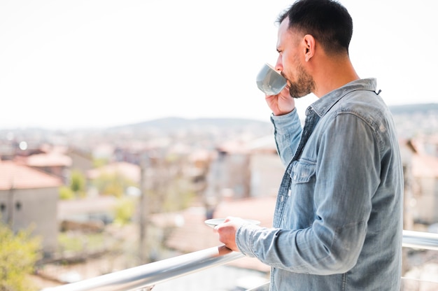 Free photo front view of man looking at city