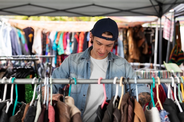 Front view man looking at clothes