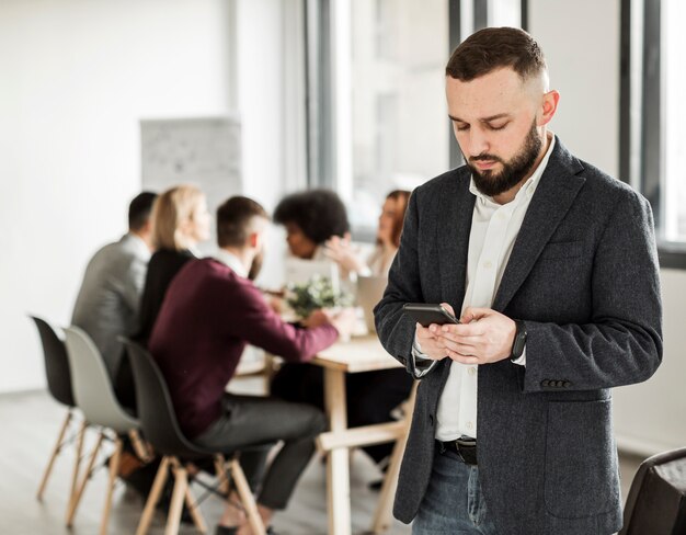 Front view of man looking at his phone