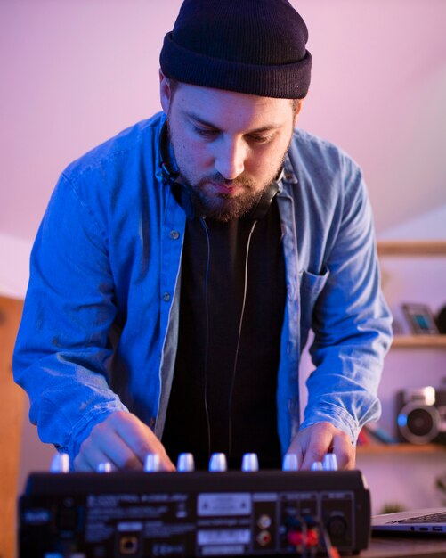 Front view man making music in bedroom