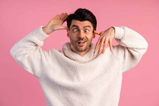 Free photo front view of man making silly faces