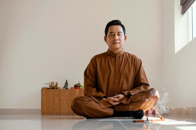 Free photo front view of man meditating