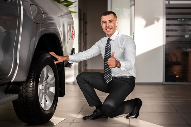 Front view man on one knee showing ok sign