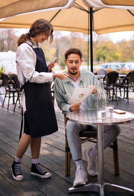 Front view man ordering at restaurant