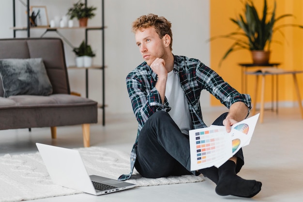 Front view of man planning on redecorating the home