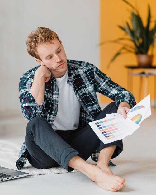 Front view of man planning on redecorating the household