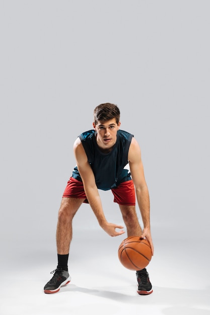 Front view man playing basketball alone