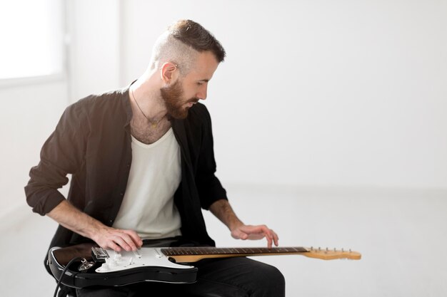 Front view of man playing electric guitar