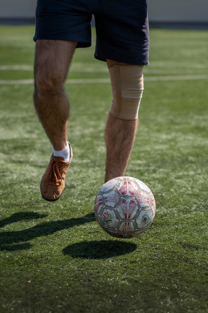 Free photo front view man playing soccer