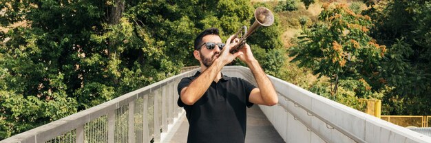 Front view of man playing the trumpet