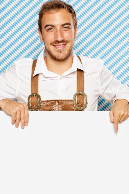 Free photo front view of man pointing at blank sign