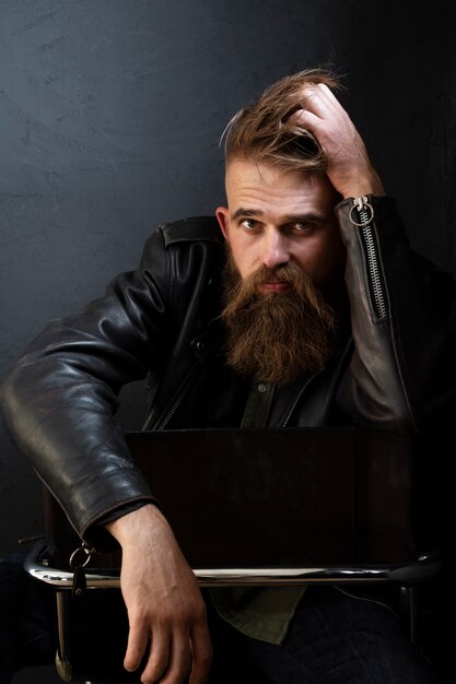 Front view man posing on chair