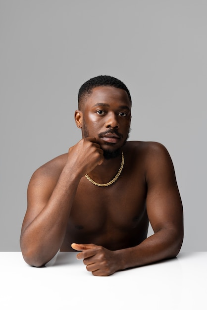 Front view man posing with necklace