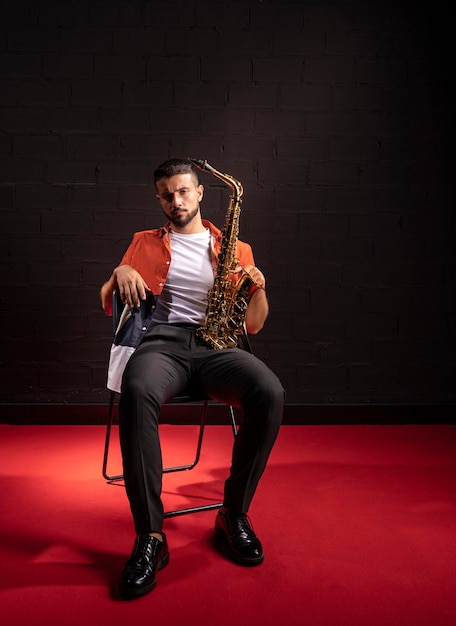 Front view of man posing with saxophone