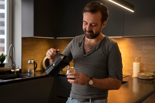 Free photo front view man pouring coffee