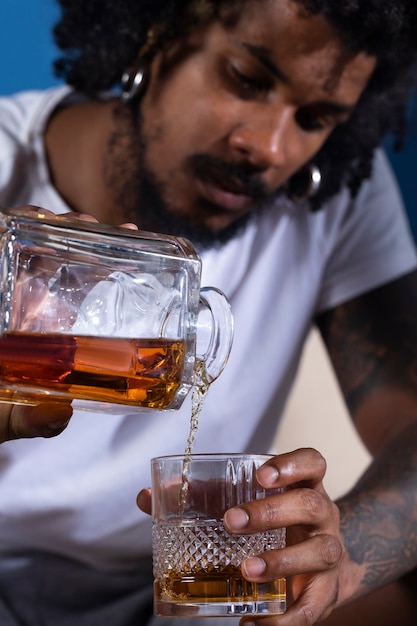 Free photo front view man pouring drink