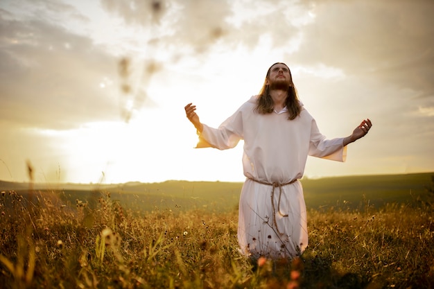 Front view man praying outdoors