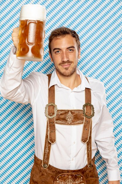 Front view of man raising beer pint