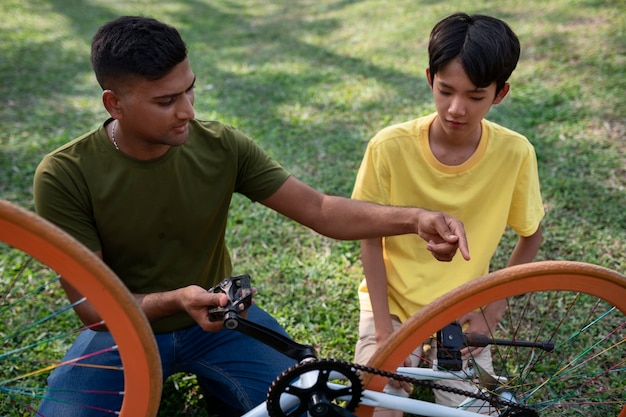 Free photo front view man repairing bicycle