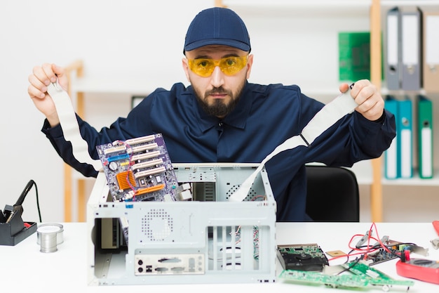 Free photo front view man repairing a computer